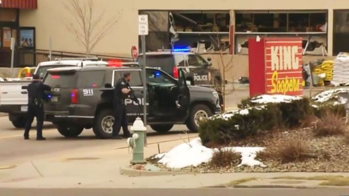 Police take positions outside the King Soopers grocery store in Boulder, Colorado, on Monday after reports of an active shooter