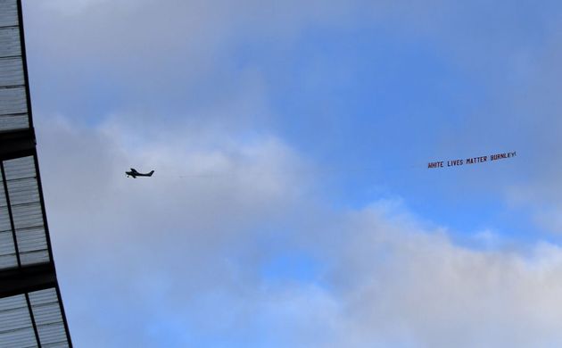 MANCHESTER, ENGLAND - JUNE 22: A plane flies over the stadium with a banner reading 'White Lives Matter Burnley'  during the Premier League match between Manchester City and Burnley FC at Etihad Stadium on June 22, 2020 in Manchester, England. Football stadiums around Europe remain empty due to the Coronavirus Pandemic as Government social distancing laws prohibit fans inside venus resulting in all fixtures being played behind closed doors. (Photo by Michael Regan/Getty Images)