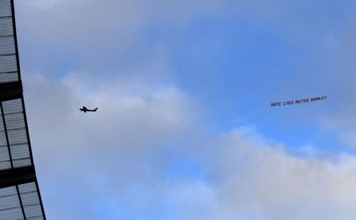 MANCHESTER, ENGLAND - JUNE 22: A plane flies over the stadium with a banner reading 'White Lives Matter Burnley' during the Premier League match between Manchester City and Burnley FC at Etihad Stadium on June 22, 2020 in Manchester, England. Football stadiums around Europe remain empty due to the Coronavirus Pandemic as Government social distancing laws prohibit fans inside venus resulting in all fixtures being played behind closed doors. (Photo by Michael Regan/Getty Images)