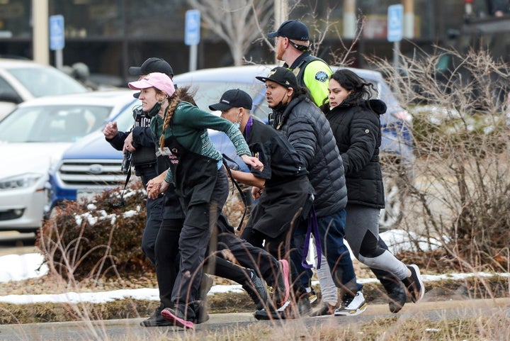 King Soopers employees being led away from an active shooter at the grocery store on Monday.