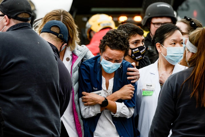 A woman consoles a King Soopers pharmacy technician after a shooting at the grocery store in Boulder, Colorado, on Monday.
