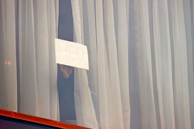 A sign is put up at a window during mandatory hotel quarantine in a Radisson Blu hotel at Heathrow Airport.