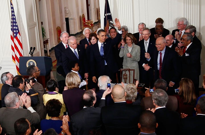 President Barack Obama is applauded after signing the Affordable Care Act during a ceremony with fellow Democrats in the East Room of the White House March 23, 2010, in Washington, D.C.