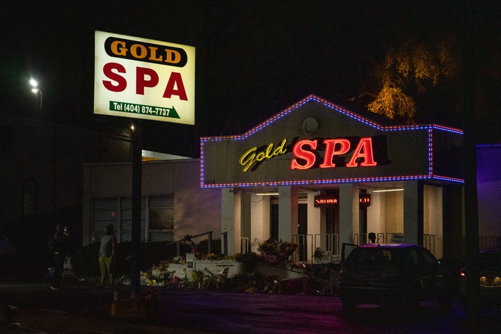 People bring flowers to a memorial outside of Gold Spa in Atlanta on March 19, 2021, after a gunman attacked three spas and killed eight people.