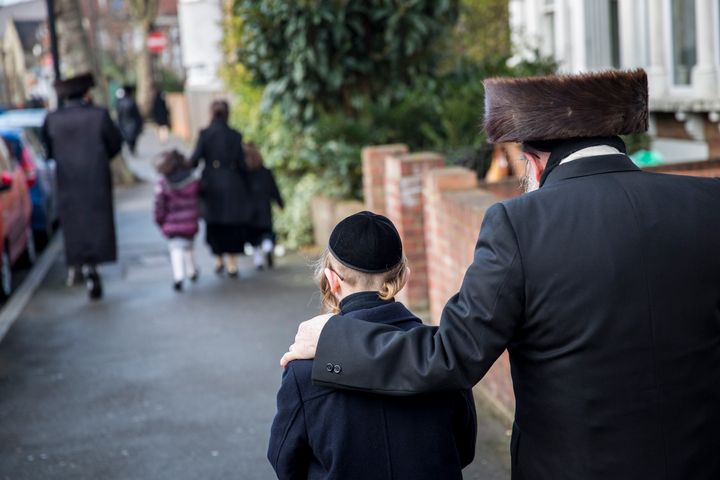 A file image showing members of the Jewish community walk along the street in Stamford Hill.