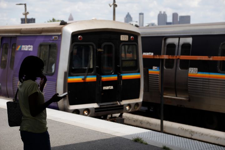 In this Tuesday, Aug. 20, 2019, photo, a woman waits to board a Metropolitan Atlanta Rapid Transit Authority train at West End Station in Atlanta.