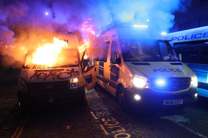 A vandalised police van on fire outside Bridewell Police Station, on Sunday 