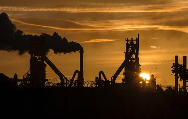 The sun rises behind a steel plant in north Lincolnshire, England, Sept. 28, 2016.