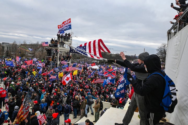 The man dubbed #SoggyKidInsider (in the foreground, holding the flag) at the Capitol on Jan. 6.