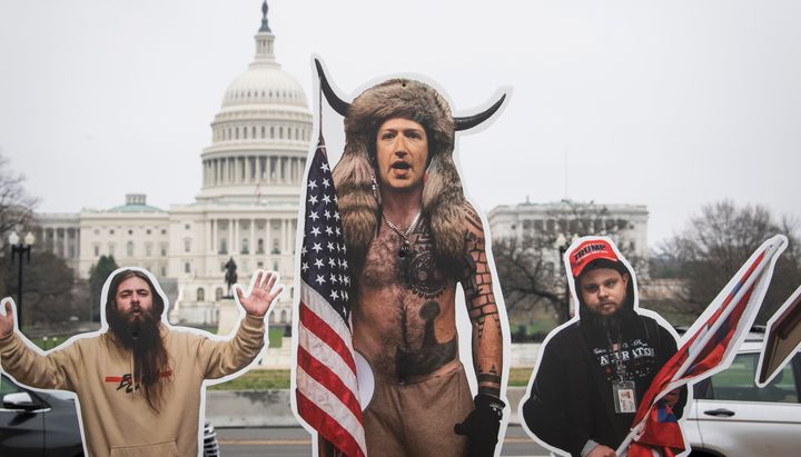A cardboard cutout of Mark Zuckerberg's head on a cutout of the "QAnon Shaman" stands on the National Mall on Thursday, ahead of a hearing on social media's role in promoting extremism and misinformation.