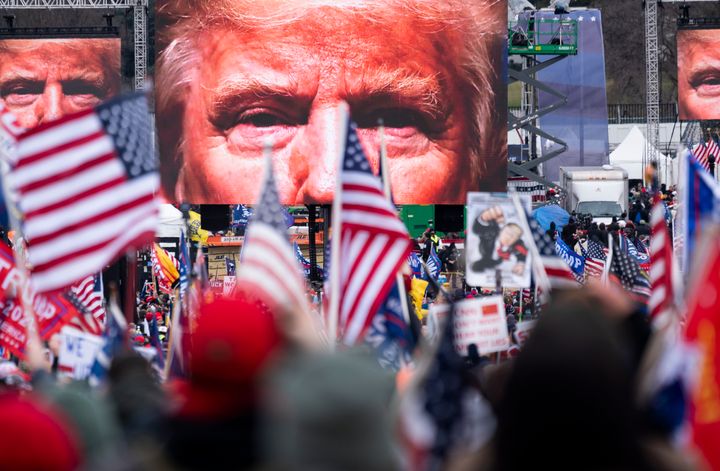 An image of President Donald Trump appears on video screens before his speech to supporters from the Ellipse at the White House, Jan. 6, 2021.