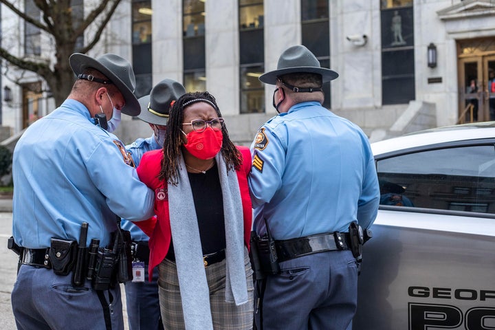 State Rep. Park Cannon (D) is placed into the back of a Georgia State Capitol patrol car after being arrested by Georgia state troopers.