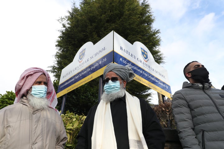 Protesters gathered outside Batley Grammar School in Batley, West Yorkshire, on Friday