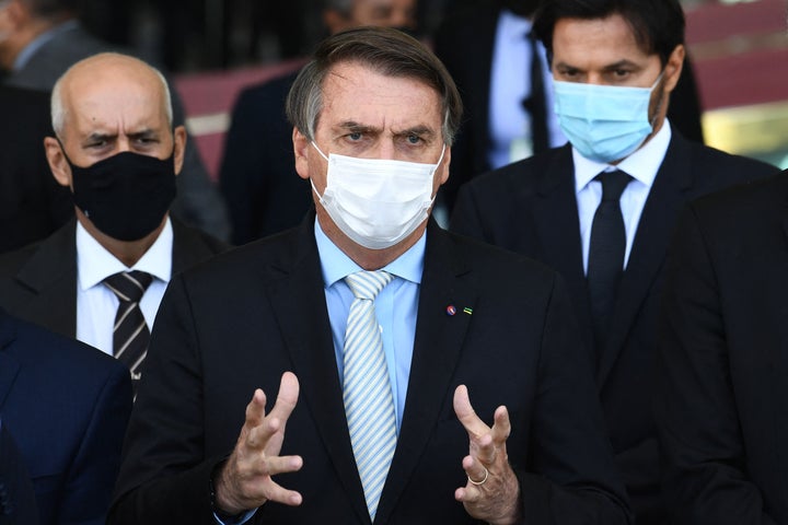 Brazilian President Jair Bolsonaro speaks to the press after meeting with the heads of the three government branches and their ministers to discuss possible solutions to the pandemic at the Alvorada Palace in Brasilia on March 24.