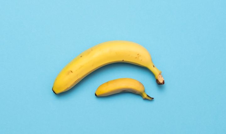 baby banana compare size with banana on blue background. size penis concept