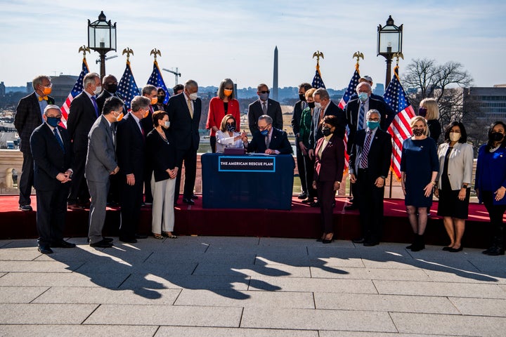 Speaker of the House Nancy Pelosi and Senate Majority Leader Chuck Schumer sign the American Rescue Plan on March 10, 2021, after the House passed the $1.9 trillion relief package. 