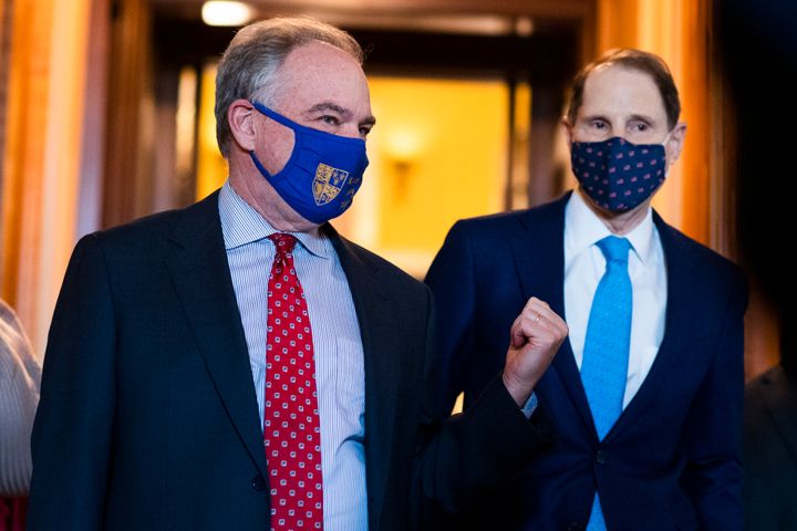 Sens. Tim Kaine (D-Va.) and Ron Wyden (D-Ore.) in the Capitol on March 23, 2021. In explaining why the American Rescue Plan disallows states from using the money for tax cuts, Wyden said: “It was important to make sure that those monies were not going to be used for another boondoggle for the very wealthy."