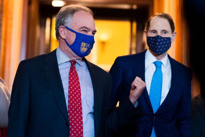 Sens. Tim Kaine (D-Va.) and Ron Wyden (D-Ore.) in the Capitol on March 23, 2021. In explaining why the American Rescue Plan disallows states from using the money for tax cuts, Wyden said: “It was important to make sure that those monies were not going to be used for another boondoggle for the very wealthy."