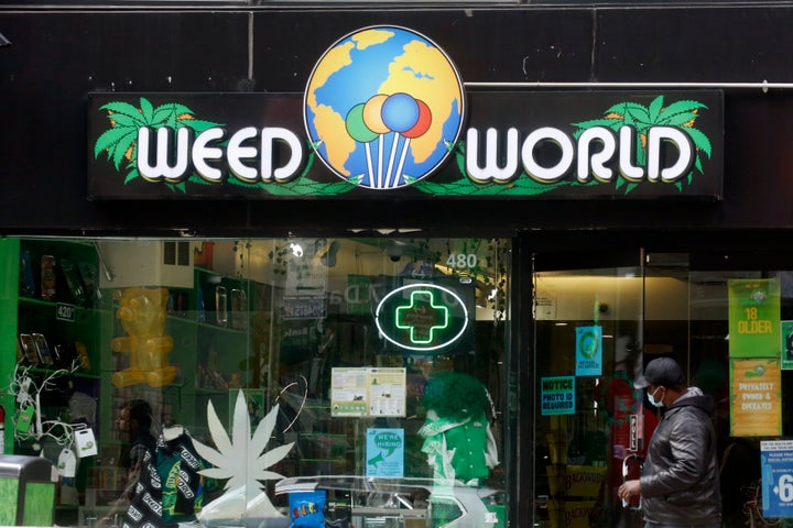 A man opens the door of the Weed World Store in New York City on Thursday. New York State has reached a deal to legalize recreational marijuana use and opened a way for an almost $4.2 billion industry that could create thousands of jobs.