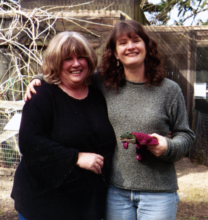 The author and her mother at the Cascade Raptor Center in Eugene, Oregon, in 2005, posing with the plastic costumed alligator