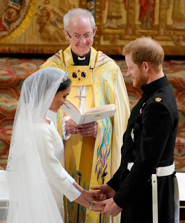 Prince Harry and Meghan Markle stand facing each other hand-in-hand before Archbishop of Canterbury Justin Welby during their wedding ceremony in St George's Chapel on May 19, 2018. 