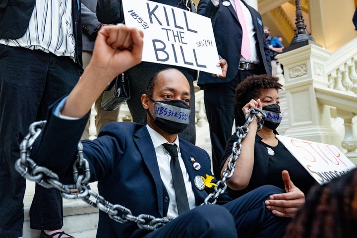 Demonstrators hold a sit-in inside the Georgia Capitol in opposition to H.B. 531, which imposes new restrictions on voting in