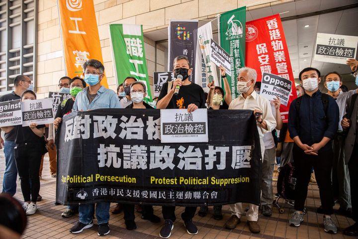 Ahead of the trial, supporters and some of the defendants gathered outside the court, shouting “Oppose political persecution” and “Five demands, not one less,” in reference to demands by democracy supporters that include amnesty for those arrested in the protests as well as universal suffrage in the semi-autonomous territory.