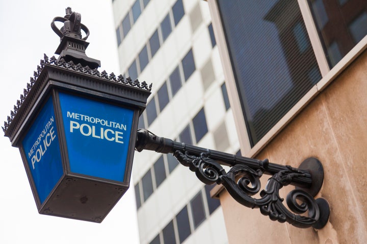 Traditional British Metropolitan Police lamp sign outside police station, London, England