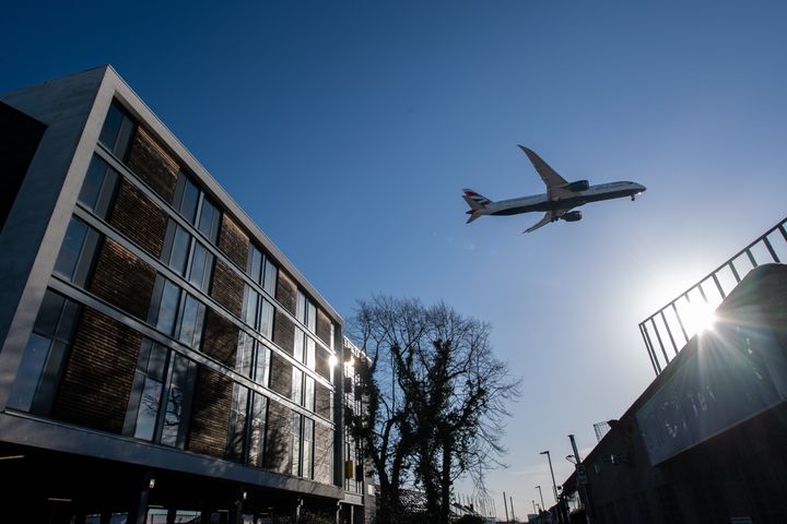 A British Airways airplane flies over a Travelodge hotel as it comes in to land at Heathrow Airport.