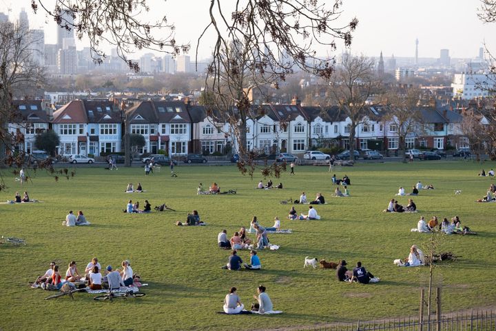 As government Coronavirus pandemic restrictions ease, with the mixing of households within groups of six coming into effect, groups of friends gather on the grass in Ruskin Park, south London, to enjoy warm Spring weather, on 30th March 2021, in London, England. (Photo by Richard Baker / In Pictures via Getty Images)