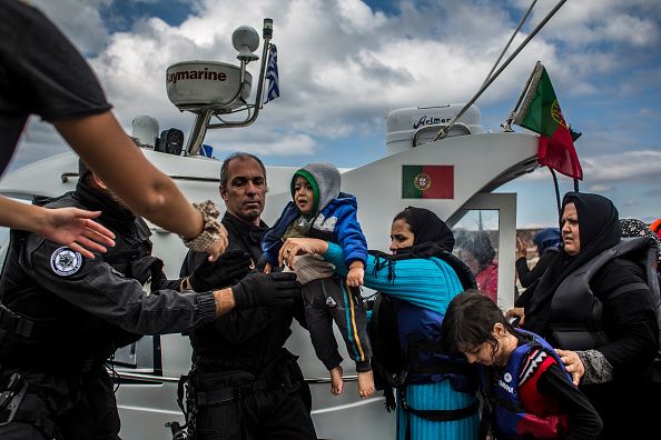 October 2, Skala Sikaminias: Members of the Portuguese Coast Guard help immigrants who crossed ...