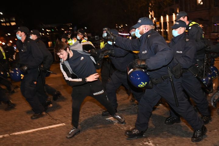 Police officers attempt to detain a man during a "Kill the Bill" protest in Bristol