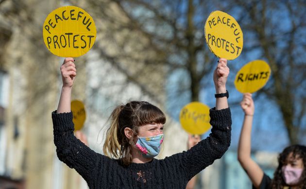 Protesters hold signs during a Kill The Bill demonstration on April 03