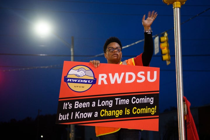 A union organizer waves to cars outside the Amazon fulfillment center in Bessemer, Alabama, during the union election.