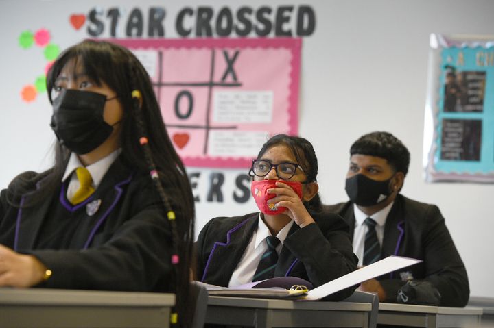 Children wearing facemasks in their Tutor Form Group listening to a virtual assembly at Hounslow Kingsley Academy in west London