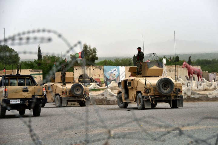 Afghan security forces stand on Humvees during a military operation in the Arghandab district of Kandahar province on Ap