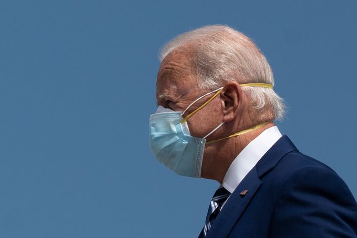 President Joe Biden wears two masks.