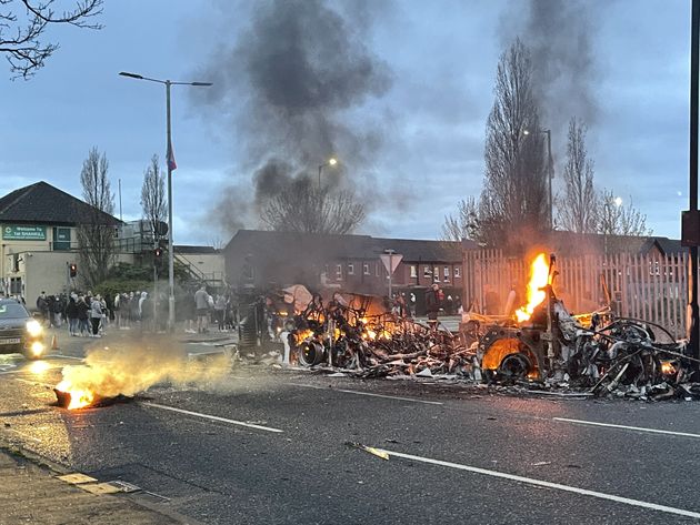 <strong>The wreckage of a Translink Metrobus on fire on the Shankill Road in Belfast during further unrest.</strong>” data-caption=”<strong>The wreckage of a Translink Metrobus on fire on the Shankill Road in Belfast during further unrest.</strong>” data-rich-caption=”<strong>The wreckage of a Translink Metrobus on fire on the Shankill Road in Belfast during further unrest.</strong>” data-credit=”Liam McBurney – PA Images via Getty Images” data-credit-link-back=”” /></p>
<div class=