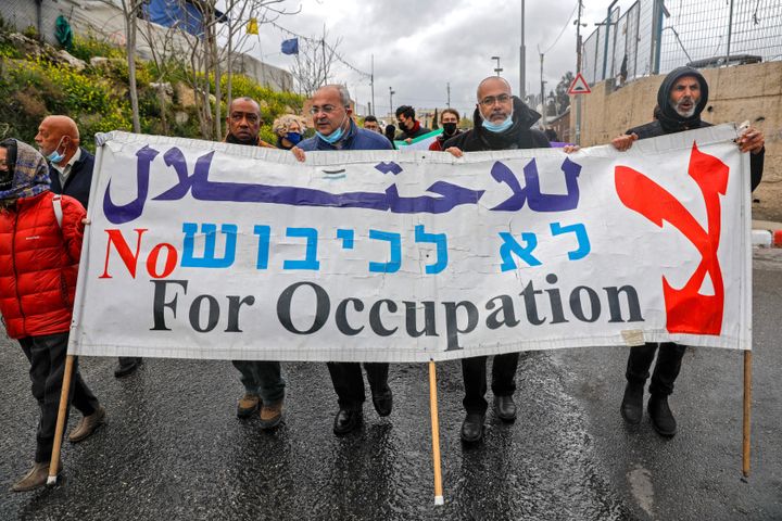 Palestinian, Israeli and foreign activists protest against Israeli occupation and settlement activities in the Palestinian Territories and east Jerusalem, in Jerusalem's Sheikh Jarrah neighborhood on April 2, 2021.