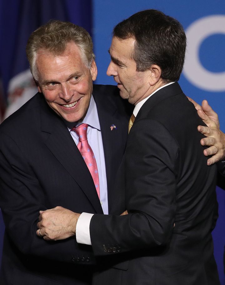 Ralph Northam, right, is embraced by Terry McAuliffe at an election night rally Nov. 7, 2017, in Fairfax, Virginia.&nbsp;