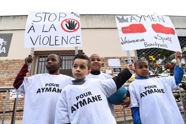 Des enfants tiennent des pancartes sur lesquelles on lit 