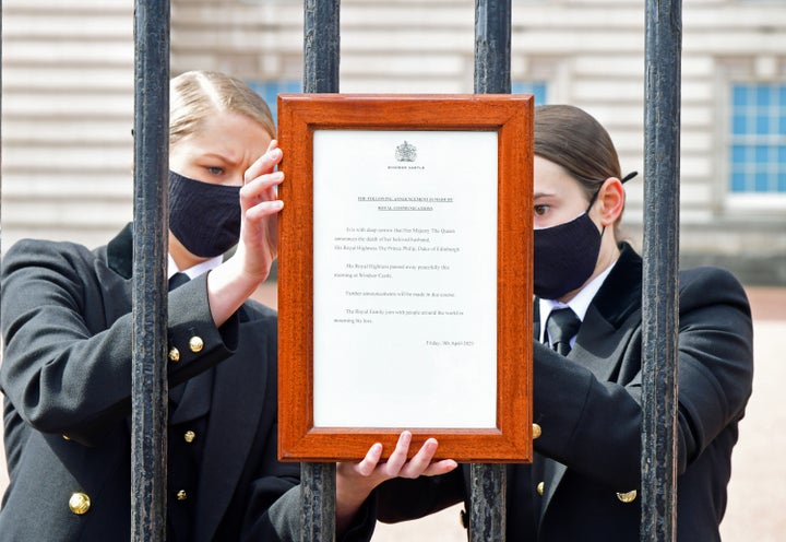 A sign announcing the death of the Duke of Edinburgh, who has died at the age of 99, is placed on the gates of Buckingham Palace.