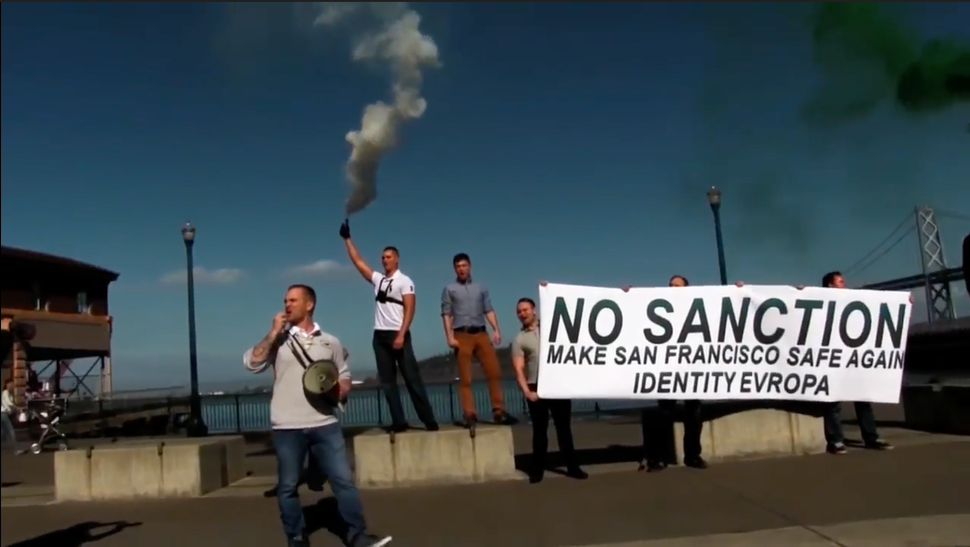 McCaffrey holds a banner during an Identity Evropa anti-immigrant demonstration in San Francisco in October 2016.