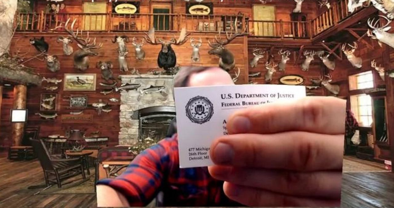 McCaffrey holds up an FBI agent's business card to the camera during a 2017 livestream. The nature of his relationship with the agency is unclear.