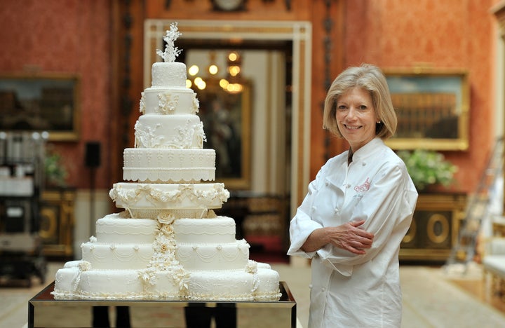 Fiona Cairns stands next to the wedding cake she and her team made for Prince William and Kate Middleton. 