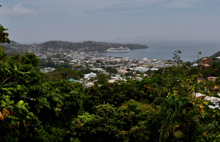 A cruise ship sits docked waiting for passengers to be evacuated in Kingstown, on the eastern Caribbean island of St. Vincent, Friday, April 9, 2021 due to the eruption of La Soufriere volcano. (AP Photo/Orvil Samuel)