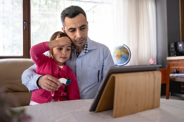 Father Talking To Family Doctor Via Video Call About His Daughter's Symptoms