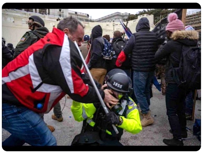 Tommy Webster is seen trying to dig his thumbs into the face of a police officer outside the Capitol on Jan. 6.