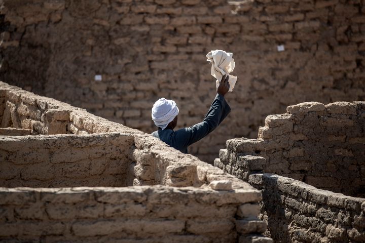 A worker at the site of the 3,400-year-old lost city of Aten on April 10 in Luxor, Egypt.