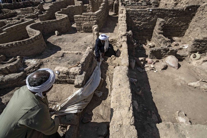 A picture taken on April 10, 2021, shows workers at the archaeological site of a 3000 year old city, dubbed The Rise of Aten,